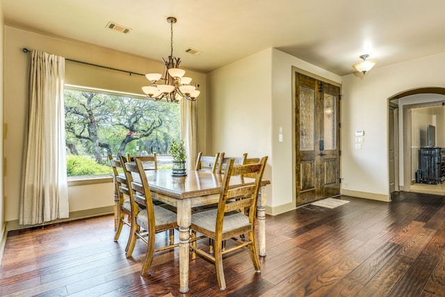 600 Mountain Dew Rd, Horseshoe Bay, TX 78657 - dining area featuring a chandelier, visible vents, arched walkways, and dark wood-style floors