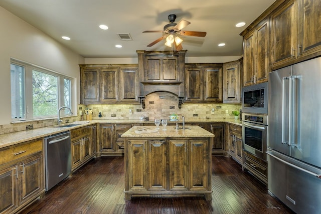 600 Mountain Dew Rd, Horseshoe Bay, TX 78657 - kitchen featuring stainless steel appliances, visible vents, an island with sink, ceiling fan, and light stone countertops