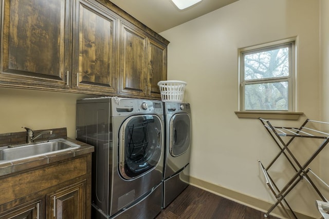 600 Mountain Dew Rd, Horseshoe Bay, TX 78657 - laundry area featuring washing machine and dryer, baseboards, a sink, cabinet space, and dark wood-style floors