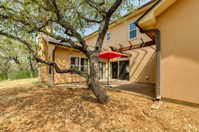 600 Mountain Dew Rd, Horseshoe Bay, TX 78657 - back of house featuring a patio and stucco siding
