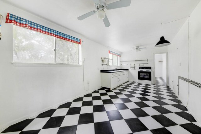 3701 Fischer Store Rd, Wimberley, TX 78676 - kitchen featuring ceiling fan, dark floors, white cabinets, and range