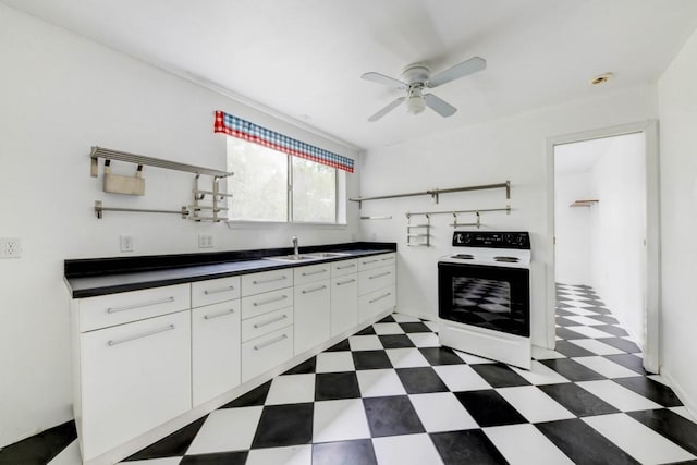 3701 Fischer Store Rd, Wimberley, TX 78676 - kitchen with a sink, dark floors, ceiling fan, electric range, and dark countertops