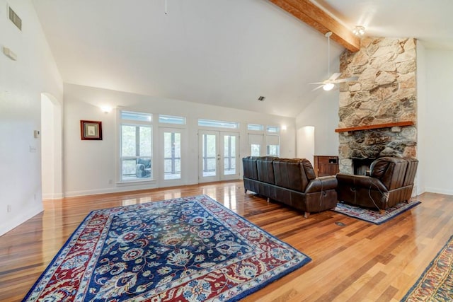 3701 Fischer Store Rd, Wimberley, TX 78676 - living room with visible vents, wood finished floors, a ceiling fan, and beamed ceiling