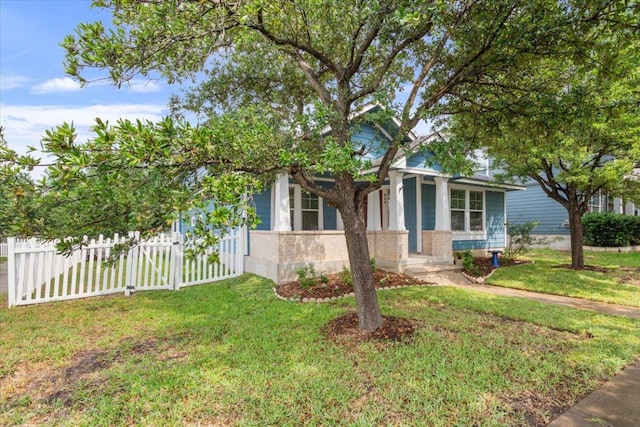 view of front of home with a front lawn and fence
