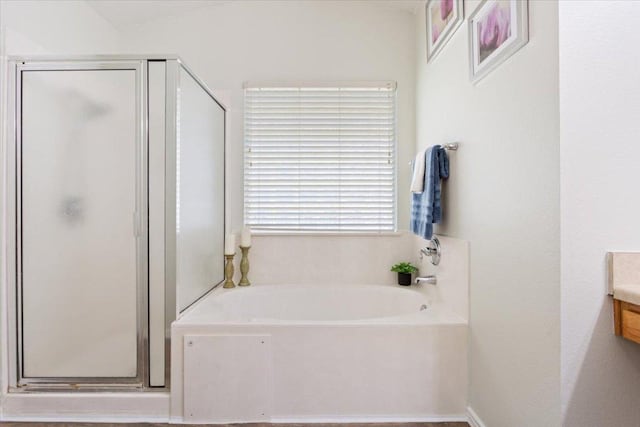 bathroom with a shower stall and a bath