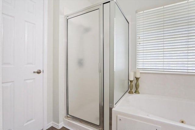 bathroom with a bath and a shower stall