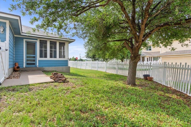 view of yard featuring a fenced backyard and a sunroom