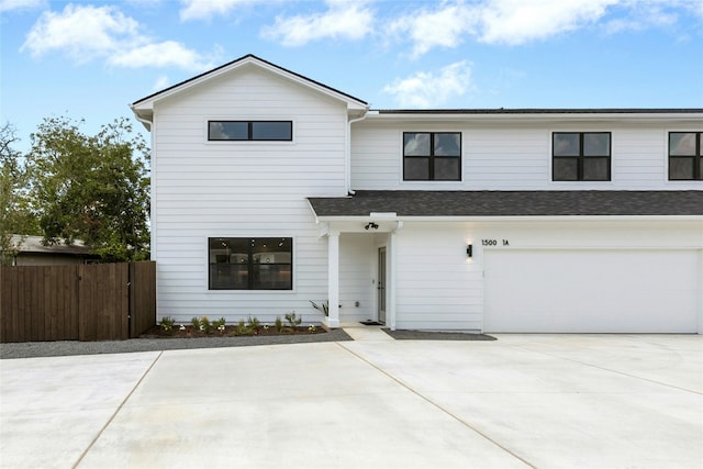 1500 Sylvan Glade Rd Unit 1A, Austin, TX 78745 - view of front of house with a garage, driveway, and a shingled roof