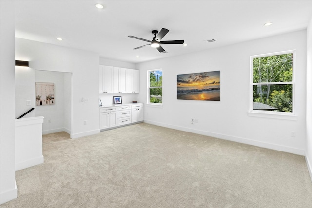 1500 Sylvan Glade Rd Unit 1A, Austin, TX 78745 - unfurnished living room with recessed lighting, light colored carpet, and a ceiling fan