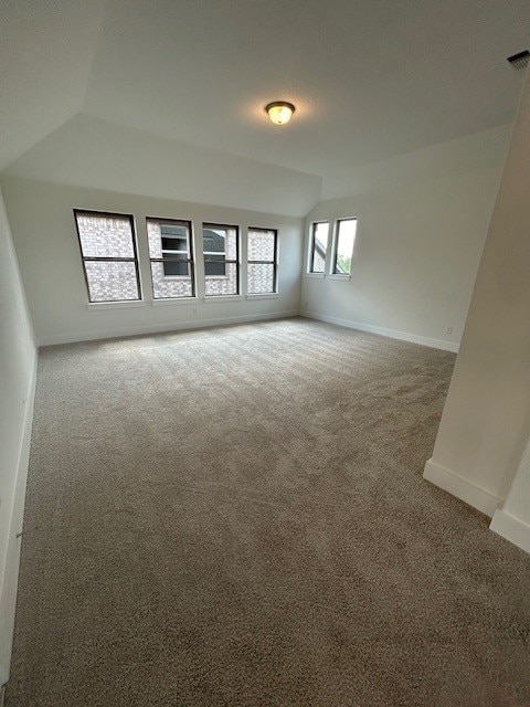 565 Raleigh Dr, Georgetown, TX 78633 - unfurnished room featuring carpet, vaulted ceiling, and baseboards