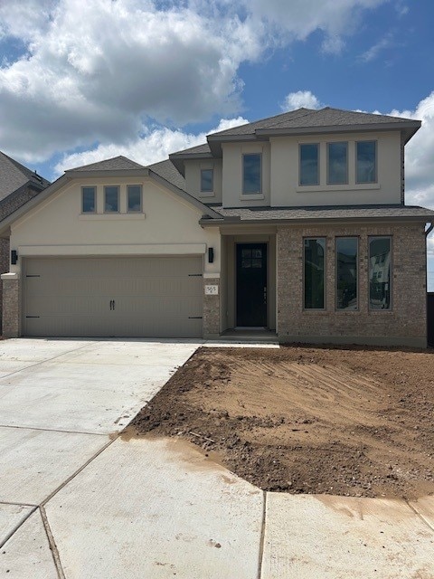 565 Raleigh Dr, Georgetown, TX 78633 - view of front of property with stucco siding, driveway, a garage, and roof with shingles