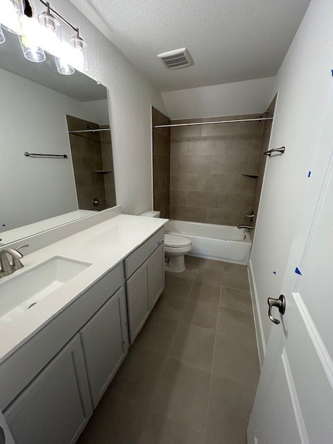 565 Raleigh Dr, Georgetown, TX 78633 - full bath with vanity, tile patterned flooring, toilet, a textured ceiling, and  shower combination