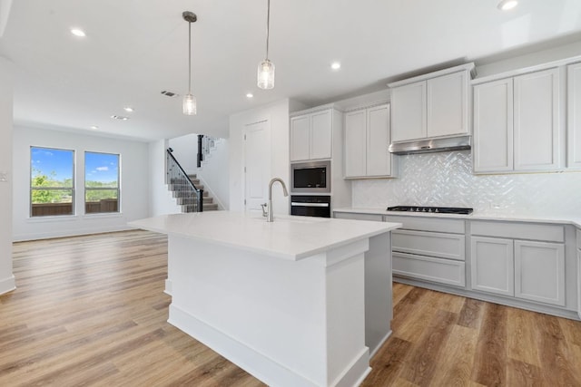 565 Raleigh Dr, Georgetown, TX 78633 - kitchen with black appliances, tasteful backsplash, recessed lighting, light countertops, and pendant lighting