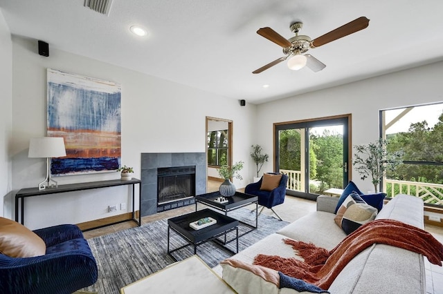living room featuring a fireplace, a ceiling fan, visible vents, and recessed lighting
