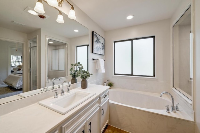 full bathroom with ensuite bathroom, vanity, visible vents, recessed lighting, and a garden tub