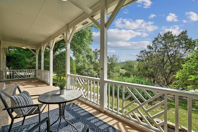 wooden terrace with a ceiling fan