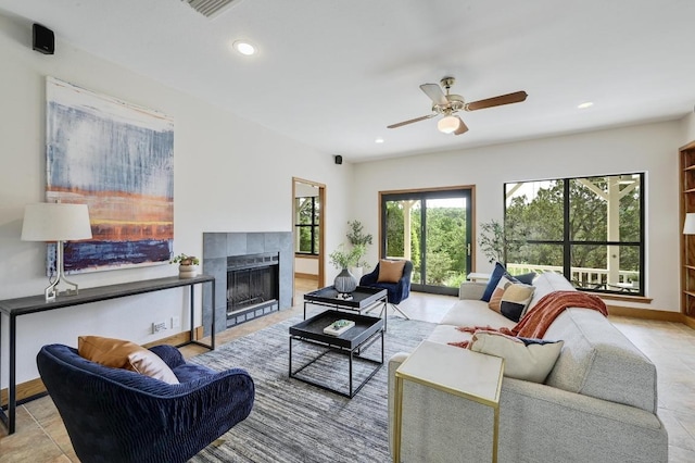 living area featuring a fireplace, baseboards, ceiling fan, and recessed lighting
