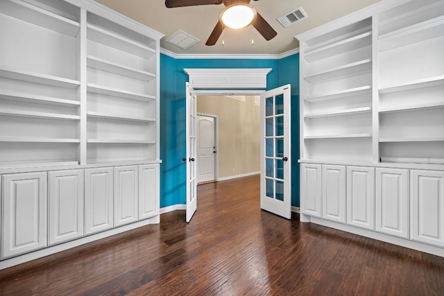 interior space with dark wood-style floors, ornamental molding, french doors, and built in shelves
