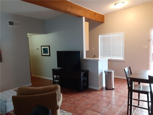 living room featuring light tile patterned floors, baseboards, and visible vents