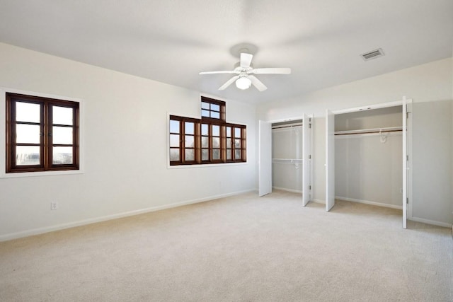 18700 Madrone Ranch Trl, Austin, TX 78738 - unfurnished bedroom featuring multiple closets, visible vents, carpet flooring, a ceiling fan, and baseboards