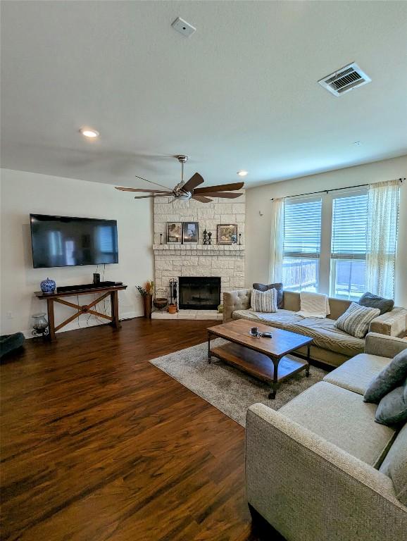 7617 Rio Pass, Austin, TX 78724 - living room with wood finished floors, a ceiling fan, a fireplace, and recessed lighting