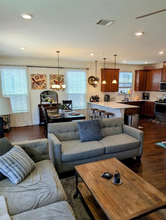 7617 Rio Pass, Austin, TX 78724 - living area with dark wood-style floors and recessed lighting