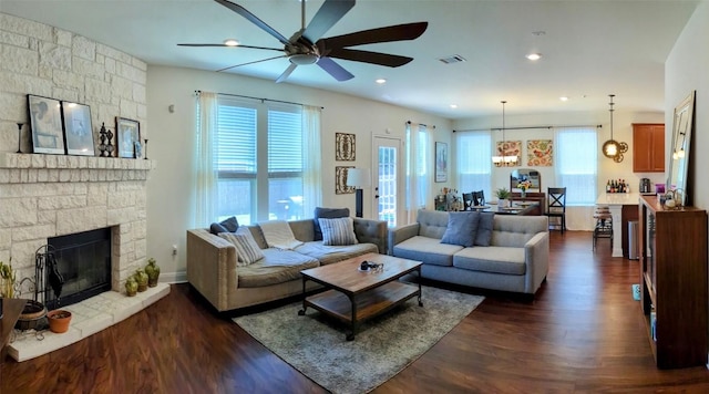 7617 Rio Pass, Austin, TX 78724 - living area featuring ceiling fan, dark wood finished floors, and a stone fireplace