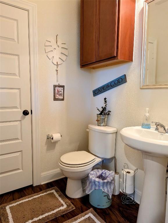 7617 Rio Pass, Austin, TX 78724 - bathroom with baseboards, toilet, wood finished floors, and a sink