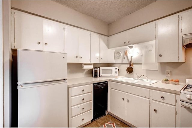 803 W 28th St Unit 105, Austin, TX 78705 - kitchen featuring a textured ceiling, white appliances, light countertops, and a sink