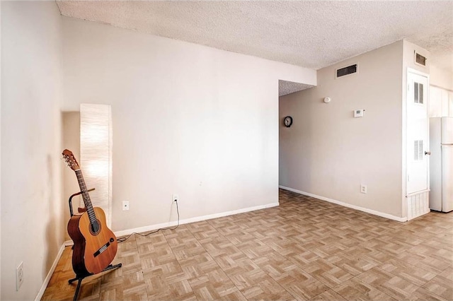803 W 28th St Unit 105, Austin, TX 78705 - spare room featuring visible vents and a textured ceiling