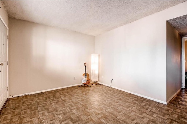 803 W 28th St Unit 105, Austin, TX 78705 - spare room featuring a textured ceiling and baseboards