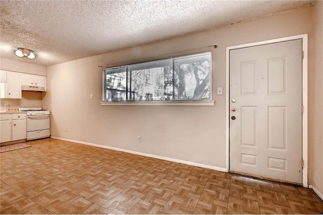 803 W 28th St Unit 105, Austin, TX 78705 - interior space featuring a textured ceiling and baseboards