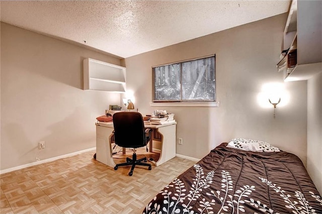 803 W 28th St Unit 105, Austin, TX 78705 - bedroom featuring a textured ceiling and baseboards