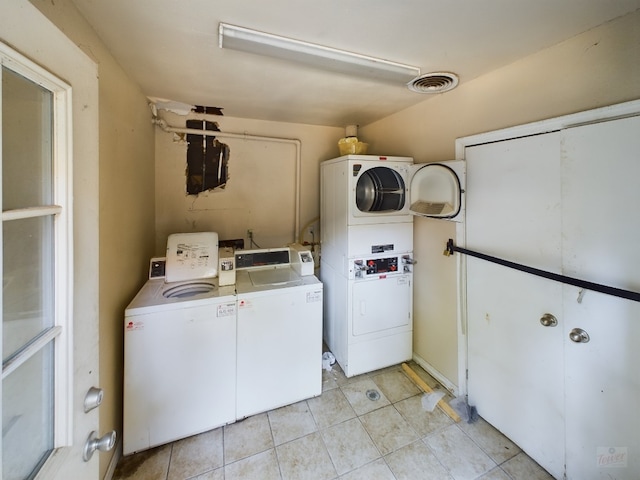803 W 28th St Unit 105, Austin, TX 78705 - shared laundry area with light tile patterned floors, stacked washing maching and dryer, independent washer and dryer, and visible vents