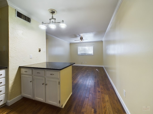 803 W 28th St Unit 206, Austin, TX 78705 - kitchen with a peninsula, crown molding, visible vents, and dark wood-style flooring