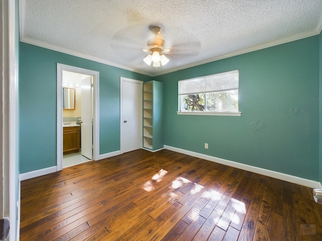 803 W 28th St Unit 206, Austin, TX 78705 - unfurnished bedroom featuring a closet, hardwood / wood-style floors, crown molding, a textured ceiling, and baseboards