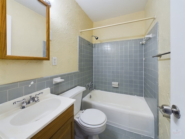 803 W 28th St Unit 206, Austin, TX 78705 - full bath featuring toilet, bathtub / shower combination, tile walls, a textured wall, and vanity
