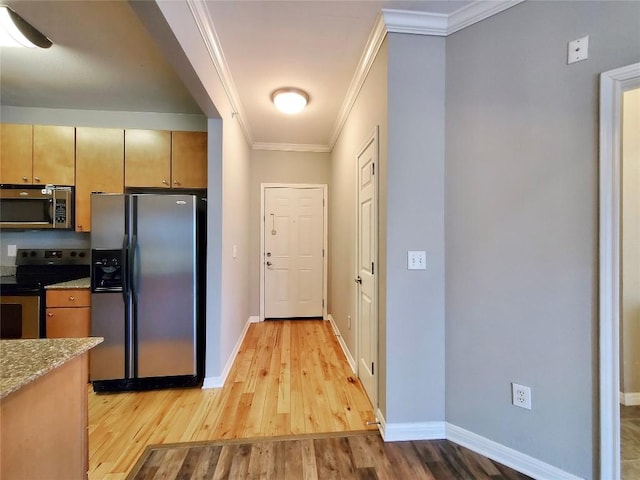 2502 Leon St Unit 515, Austin, TX 78705 - kitchen with light stone countertops, baseboards, crown molding, light wood-style floors, and stainless steel appliances