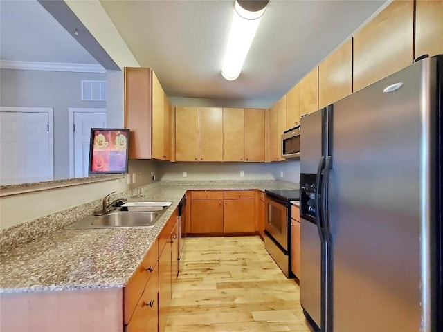 2502 Leon St Unit 515, Austin, TX 78705 - kitchen featuring light brown cabinetry, light wood finished floors, a sink, crown molding, and appliances with stainless steel finishes
