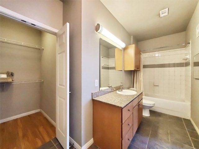 2502 Leon St Unit 515, Austin, TX 78705 - full bathroom with toilet, wood finished floors, vanity, baseboards, and shower / bathtub combination with curtain