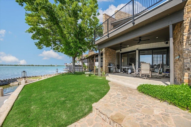 402 Island Dr Unit C, Horseshoe Bay, TX 78657 - view of yard with a balcony, a patio, a ceiling fan, a water view, and outdoor dining area