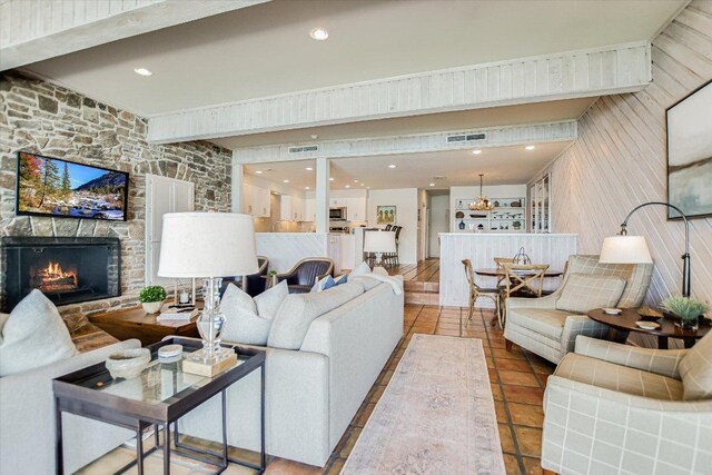 402 Island Dr Unit C, Horseshoe Bay, TX 78657 - living room featuring visible vents, tile patterned flooring, a stone fireplace, wooden walls, and recessed lighting