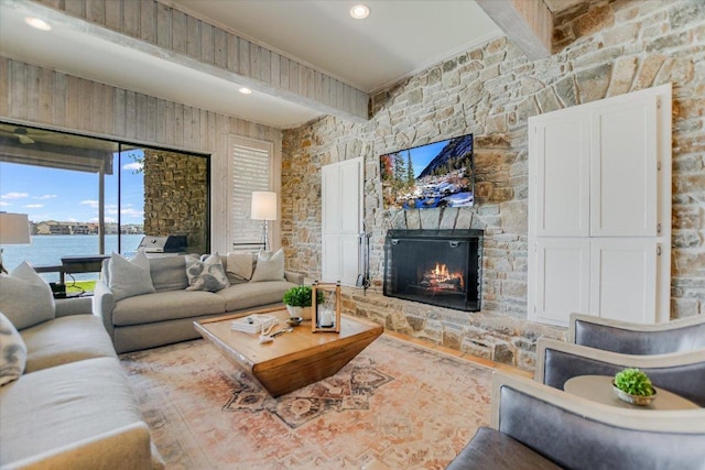402 Island Dr Unit C, Horseshoe Bay, TX 78657 - living room with a water view, beamed ceiling, and a stone fireplace
