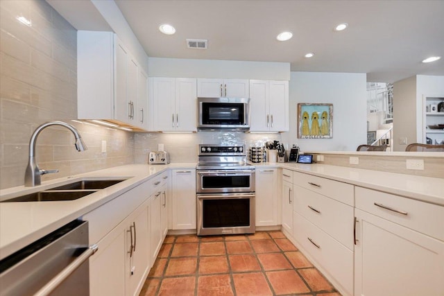 402 Island Dr Unit C, Horseshoe Bay, TX 78657 - kitchen with backsplash, appliances with stainless steel finishes, visible vents, and a sink