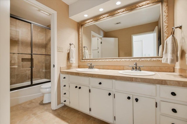 402 Island Dr Unit C, Horseshoe Bay, TX 78657 - bathroom with a sink, double vanity, toilet, and combined bath / shower with glass door