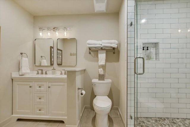 402 Island Dr Unit C, Horseshoe Bay, TX 78657 - full bathroom with toilet, vanity, visible vents, a shower stall, and baseboards