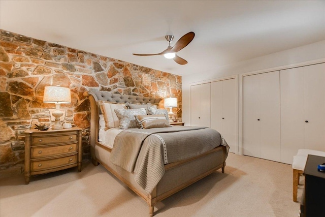402 Island Dr Unit C, Horseshoe Bay, TX 78657 - bedroom with multiple closets, ceiling fan, and light colored carpet