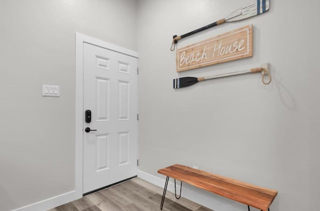 102 W Corral St Unit 2, South Padre Island, TX 78597 - doorway to outside featuring baseboards and wood finished floors