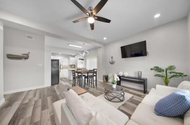 102 W Corral St Unit 2, South Padre Island, TX 78597 - living room with baseboards, visible vents, light wood-style flooring, and a ceiling fan