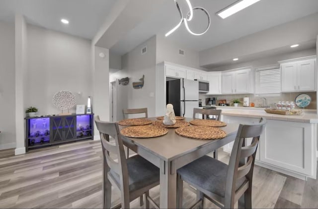 102 W Corral St Unit 2, South Padre Island, TX 78597 - dining area featuring recessed lighting, light wood finished floors, and visible vents